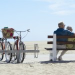 couple sitting on bench with bicycles