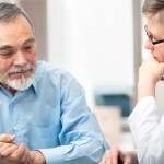 older man in consultation with doctor