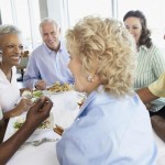 group of older people round table eating