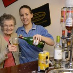 Resident Helen Brown, 85, and carer Nicola Pattison, try out the Ship Inn pub in Bupa Elderslie Care Home credit SWNS