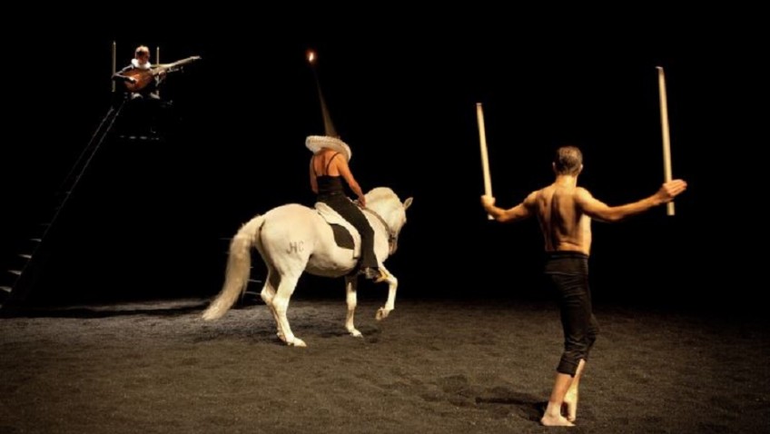 A religious ritual with horses on stage