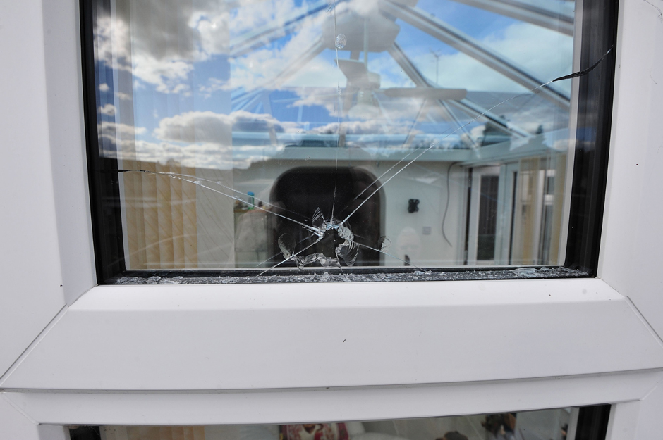 Broken window at Les Bayliss and his mother Anita Griffiths house - Copyright SWNS.com - Credit Jonathan Barry/SWNS.com