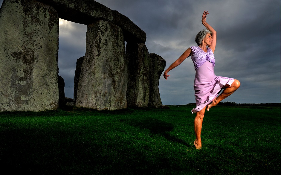 older woman dancing in Stonehenge