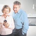 Older couple using mobile phone