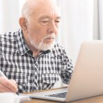 Older man using laptop