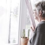 Older woman looking out of window - Nosey neighbour