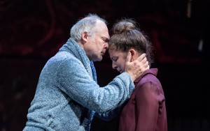 older man holding younger woman's face