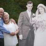 couple celebrating next to cut outs of wedding photo