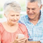 Older couple learning how to use a smartphone